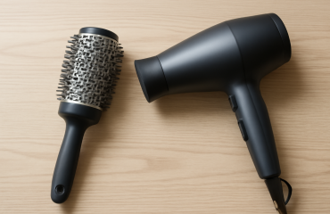 brosse ronde et seche-cheveux posés sur table